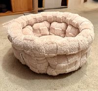 Front angled view of Bella Lux round plush pet bed showing exterior texture and shape