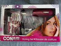 Front of sealed Conair miniPRO Styling Set box showing dryer, straightener and brush set