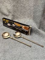 Box with two silver-plated serving pieces displayed