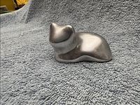 Left front view of polished aluminum cat figurine