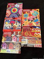 Five puzzle boxes stacked showing all designs
