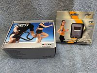 Closed boxes of Polar A5 heart rate monitor and Iron Body pedometer