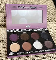 Open palette showing mirror and 8 cream eyeshadow shades