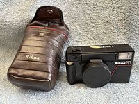 Camera and case front view with cap attached