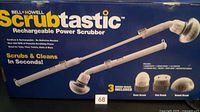 Front of unopened box showing Bell + Howell Scrubtastic rechargeable power scrubber