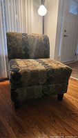 Front view of patterned armless slipper chair