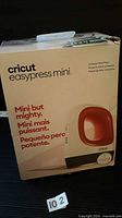 Front of boxed Cricut Easypress Mini showing product image and branding