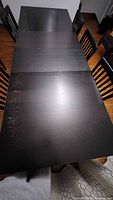 Top view of rectangular black dining table with chairs