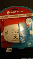 Front view of sealed First Alert carbon monoxide alarm in packaging