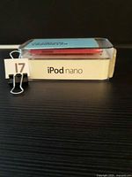 Side view of clear plastic case showing white base printed "iPod nano" and pink device inside