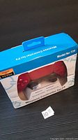 Front of unopened box showing red T29 wireless controller through window