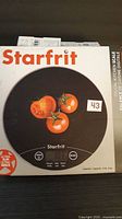 Front of retail box showing Starfrit digital kitchen scale image and capacity