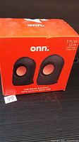 Front view of red onn box showing speaker image