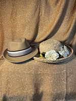 Both hats side by side on backdrop