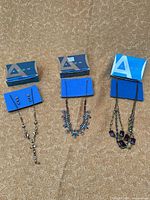 Overview of three necklaces with Avon boxes