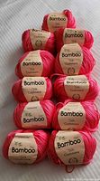 Stack of coral Everyshine bamboo silk cashmere yarn skeins
