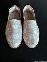 Top view of both shoes showing canvas pattern and brand on insole