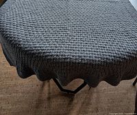 Blanket draped over table showing overall color and texture