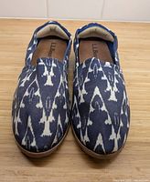 Top view of pair of blue and white patterned slip-on shoes