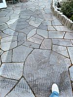 Netting unrolled across stone path showing mesh pattern and width