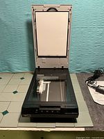 Scanner open showing glass bed and lid transparency unit