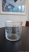Side view of clear glass ice bucket on table