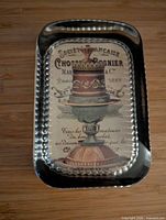 Top view of glass paperweight showing cake graphic and beveled edge