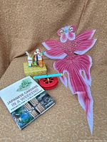 Overview of kite, horse figurine, book and reel