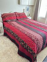 Quilt and shams on bed, full view