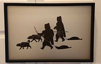 Front view of framed metal print showing Inuit hunters with dogs and seals
