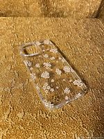 Front view of clear floral iPhone 14 case