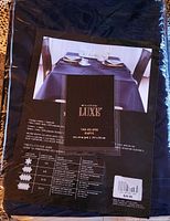 Front of sealed Wheatstone Luxe tablecloth package showing dimensions and branding