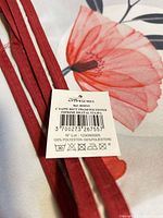 Label showing dimensions 150x240 cm, material 100% polyester, anti-stain, barcode