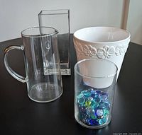 Group shot: ceramic pot, glass jug, rectangular vase, cylindrical vase with marbles