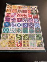 Front of Cobble Hill puzzle box showing quilt block image and branding