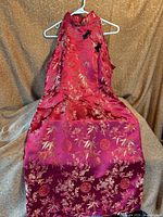 Front view of red brocade cheongsam cocktail dress on hanger