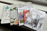 Group shot of four books and coloring placemat pad