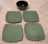 Top view showing four square green plates and one green bowl