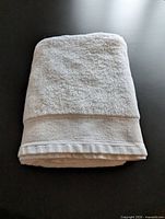 Folded white GlucksteinHome towel showing overall appearance and texture