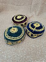 Three velvet Turkish hats showing all colours and embroidery