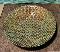 Top view of metallic turquoise and gold shallow bowl showing geometric pattern