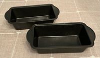 Top view of both loaf pans showing interiors and handles