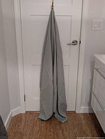 One bath sheet hanging on hook to show size and color