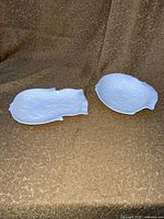 Both white fish shaped dishes side by side on surface