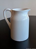 Side view of white ceramic jug showing shape and handle