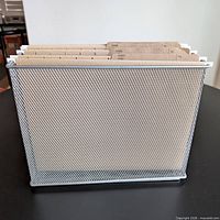 Full view of mesh basket with hanging folders inserted