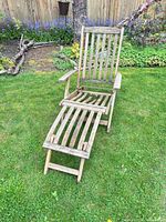 Front view of wood slat sun lounger set up on lawn