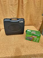 Closed black carry case beside boxed Coleman pump