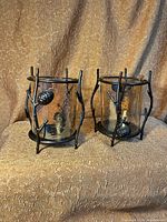 Front view of both wrought iron amber glass candle holders