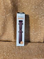 Front of boxed melkco YUNO selfie stick